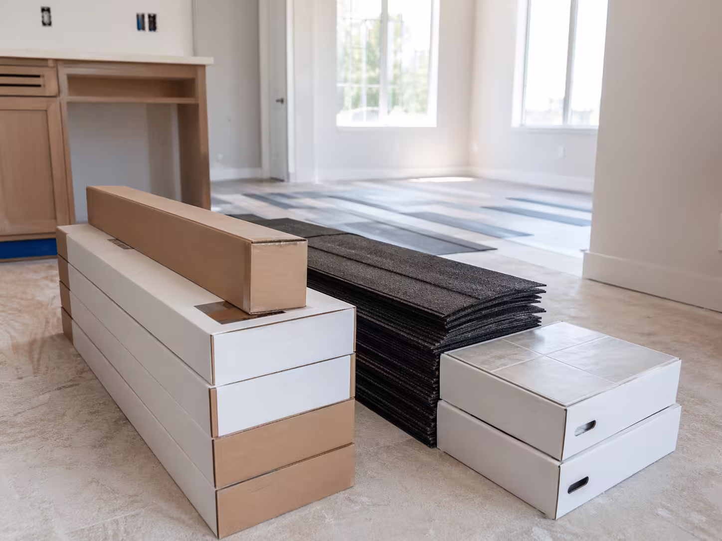 Jobsite stockpile of extra flooring and tile material representing the typical 10% to 15% waste factor buffer